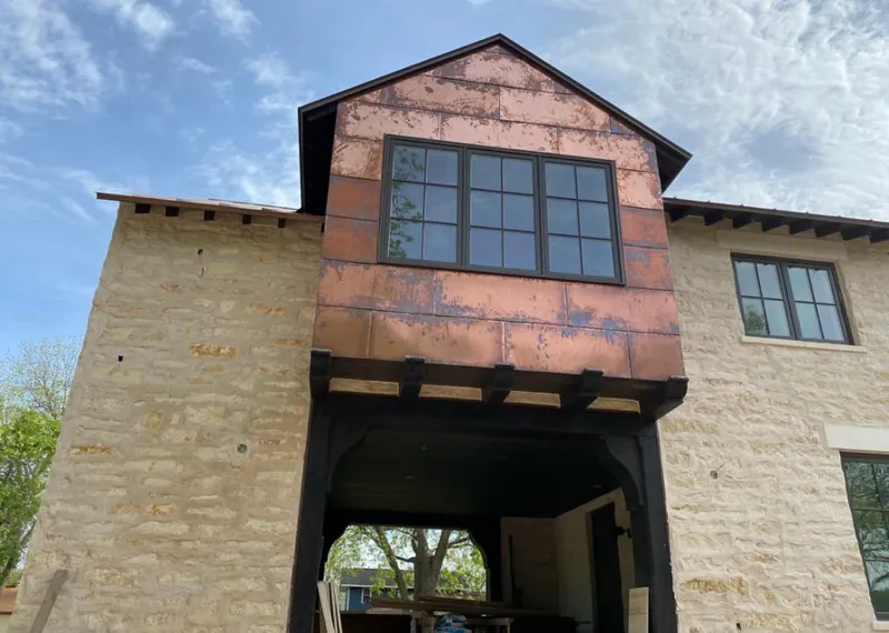 Copper metal panel facade on a stone building for Roof Repair in The Colony