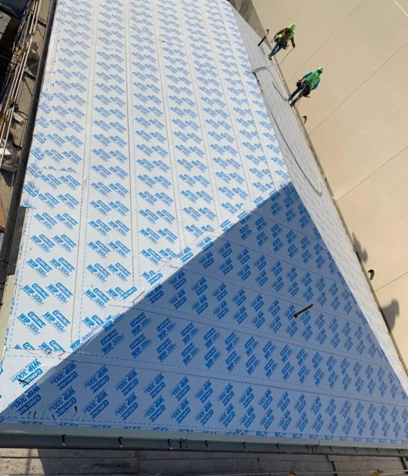 Professional roofers installing underlayment on a metal roof in The Colony